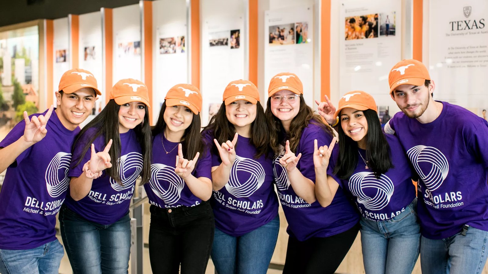 A group of Dell Scholars at UT Austin making the "Hook 'Em" Longhorns sign with their hands.
