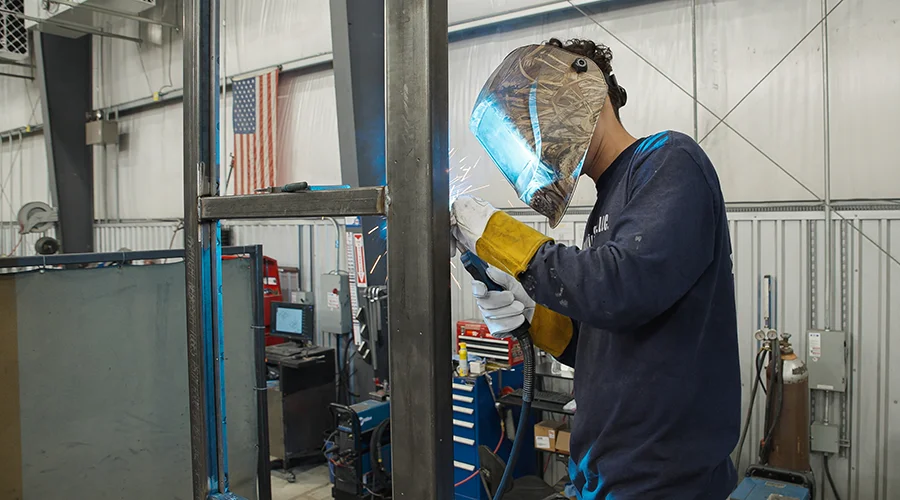 A P-TECH student welding at work.