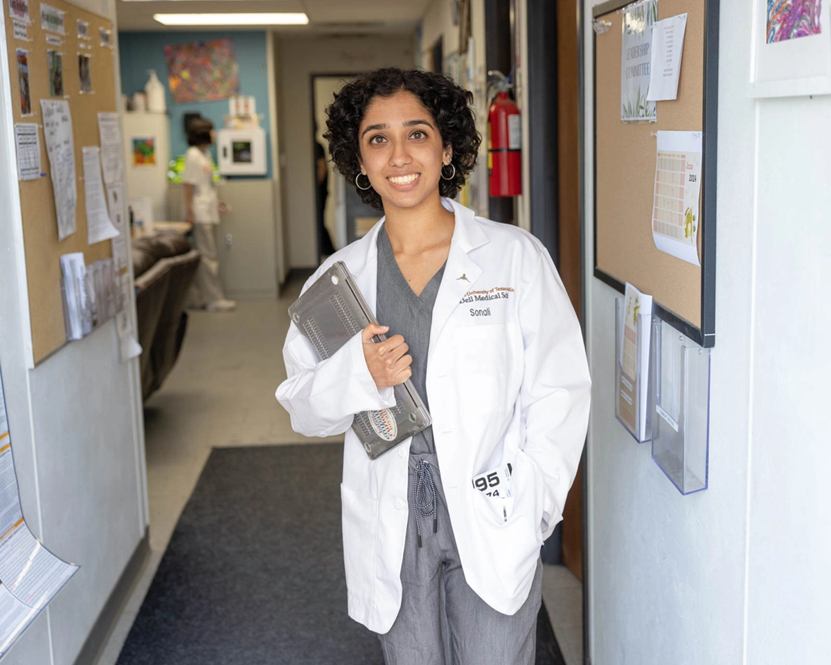 Sonali stands in the hallway of the C.D. Doyle Clinic.