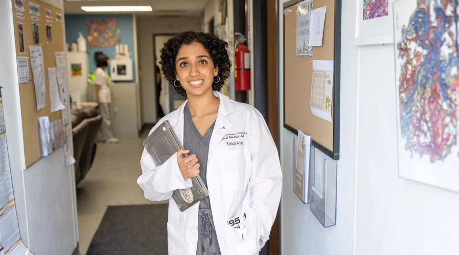 Sonali stands in the hallway of the C.D. Doyle Clinic.